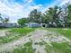 The backyard features a large storage shed and mature trees throughout the property at 2120 Dille St, Lakeland, FL 33815