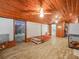 Spacious bonus room with wood ceilings and flooring, featuring a bed and ample storage space at 2120 Dille St, Lakeland, FL 33815