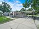Single-story home with a carport, a truck and a small storage shed in the background at 2120 Dille St, Lakeland, FL 33815