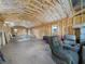 Spacious garage with wood beam ceiling and natural light from multiple windows at 2120 Dille St, Lakeland, FL 33815