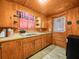 Compact kitchen featuring wooden cabinetry, a stainless steel sink, and laminate countertop at 2120 Dille St, Lakeland, FL 33815