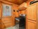 Kitchen area featuring wood cabinets and an electric range at 2120 Dille St, Lakeland, FL 33815