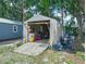 Storage shed with open door, filled with lawn care items and various tools at 2120 Dille St, Lakeland, FL 33815