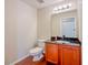 Bathroom features a mirror, vanity with a black countertop, and fixtures at 222 Carpenters Way # 65, Lakeland, FL 33805