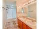 Double sink vanity provides convenience, complemented by a well-lit mirror, shower and neutral accents at 222 Carpenters Way # 65, Lakeland, FL 33805