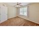 Bedroom with neutral walls, ceiling fan, and a view of the pool at 222 Carpenters Way # 65, Lakeland, FL 33805