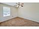 A bright bedroom with a ceiling fan, window and neutral walls provides a calming and inviting atmosphere at 222 Carpenters Way # 65, Lakeland, FL 33805