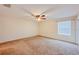 This expansive bedroom is well-lit by a window and a ceiling fan, providing a welcoming atmosphere at 222 Carpenters Way # 65, Lakeland, FL 33805