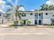 Two-story townhouse with light blue siding, white accents, and a well-maintained landscaped front at 222 Carpenters Way # 65, Lakeland, FL 33805