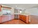 Kitchen with stainless steel dishwasher, wooden cabinets, stone countertop, and hardwood flooring at 222 Carpenters Way # 65, Lakeland, FL 33805