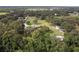 Aerial view of a spacious property with a house, outbuildings, and a long driveway surrounded by trees at 2331 D R Bryant Rd, Lakeland, FL 33810
