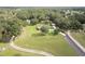 Aerial view of the property featuring a large lot with a house, garage, and a winding dirt driveway at 2331 D R Bryant Rd, Lakeland, FL 33810