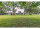 Spacious backyard with mature trees and distant buildings, ideal for outdoor activities and relaxation at 2331 D R Bryant Rd, Lakeland, FL 33810