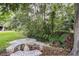 Charming outdoor space featuring a mosaic picnic table alongside a peaceful stream at 2331 D R Bryant Rd, Lakeland, FL 33810