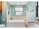 Bright bathroom featuring a soaking tub with tile surround and granite countertops at 2331 D R Bryant Rd, Lakeland, FL 33810
