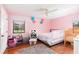 Pink bedroom featuring hardwood floors, ceiling fan, and natural light at 2331 D R Bryant Rd, Lakeland, FL 33810