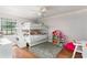 Cozy bedroom with hardwood floors, ceiling fan, and a bunk bed at 2331 D R Bryant Rd, Lakeland, FL 33810