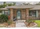 Inviting front entrance to a brick home with landscaped garden beds and a charming welcome sign at 2331 D R Bryant Rd, Lakeland, FL 33810