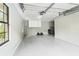Spacious garage with ample room for parking, storage cabinets and natural light from a window at 2331 D R Bryant Rd, Lakeland, FL 33810