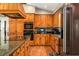Granite countertops, central island, wood cabinets and flooring define this well appointed kitchen at 2331 D R Bryant Rd, Lakeland, FL 33810