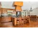 Open concept kitchen with wood cabinets, granite countertops, an island with seating, and modern appliances at 2331 D R Bryant Rd, Lakeland, FL 33810
