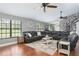 Spacious living room with wood floors, a comfortable leather sectional, and bright natural light at 2331 D R Bryant Rd, Lakeland, FL 33810