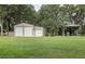 Large outbuilding with multiple roll-up doors, and an open-air area perfect for various activities at 2331 D R Bryant Rd, Lakeland, FL 33810