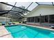 Sparkling swimming pool with screened-in enclosure, lounge chairs, and a glimpse of the house at 2331 D R Bryant Rd, Lakeland, FL 33810