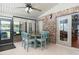 Sunroom features a brick accent wall, tile flooring, dining table, and sliding glass doors to the outside at 2331 D R Bryant Rd, Lakeland, FL 33810