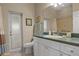 Bright bathroom with a white vanity, large mirror, and direct access to the outdoors at 2593 Colonel Ford Dr, Lakeland, FL 33813