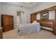 Comfortable bedroom featuring carpet flooring, wooden furniture, and neutral wall color with lots of light at 2593 Colonel Ford Dr, Lakeland, FL 33813