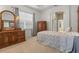 Bright bedroom with carpet flooring, a window with blinds, classic furniture, and neutral decor at 2593 Colonel Ford Dr, Lakeland, FL 33813