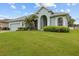 Charming home with manicured lawn, mature landscaping, and a light blue exterior for a serene curb appeal at 2593 Colonel Ford Dr, Lakeland, FL 33813