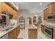 Open kitchen featuring granite countertops, stainless steel appliances, and an island workspace at 2593 Colonel Ford Dr, Lakeland, FL 33813