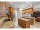 Open kitchen featuring granite countertops, stainless steel appliances, and ample cabinet space at 2593 Colonel Ford Dr, Lakeland, FL 33813