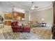 Open-concept living room with ceiling fan, comfortable seating, and view into the kitchen at 2593 Colonel Ford Dr, Lakeland, FL 33813