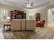 Bright living room showcases ceiling fan, built-in shelving, and comfortable upholstered seating at 2593 Colonel Ford Dr, Lakeland, FL 33813
