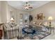 Relaxing living room with tile flooring, comfortable seating, and sliding glass doors leading to the outdoor pool area at 2593 Colonel Ford Dr, Lakeland, FL 33813