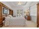 Spacious main bedroom with tray ceiling, a large bed, wooden furniture, and access to the pool area at 2593 Colonel Ford Dr, Lakeland, FL 33813