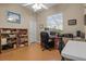 Inviting office space featuring wood floors, a large window, and ample workspace at 2593 Colonel Ford Dr, Lakeland, FL 33813