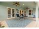 Relaxing covered patio with comfortable lounge chairs and ceiling fans, ideal for outdoor enjoyment at 2593 Colonel Ford Dr, Lakeland, FL 33813