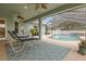 Inviting outdoor area featuring a screened-in pool with lounge chairs and a tranquil setting at 2593 Colonel Ford Dr, Lakeland, FL 33813