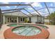 A luxurious spa and pool combination is nestled within a screened enclosure, perfect for relaxation at 2593 Colonel Ford Dr, Lakeland, FL 33813