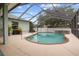 Relaxing screened pool area with brick trim and attached spa at 2593 Colonel Ford Dr, Lakeland, FL 33813