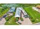 Aerial view of the home with lush landscaping, RV parking, and proximity to a serene pond at 3261 Fish Hawk Dr, Polk City, FL 33868