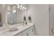 Well-lit bathroom with a modern vanity, decorative seashell, and walk-in shower with glass door at 3261 Fish Hawk Dr, Polk City, FL 33868