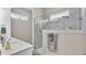 Modern bathroom featuring dual sinks, a glass-enclosed shower with stylish tiles, and decorative accents at 3261 Fish Hawk Dr, Polk City, FL 33868
