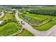 Aerial view of the community entrance featuring landscaping, water feature, and a gatehouse at 3261 Fish Hawk Dr, Polk City, FL 33868