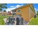Rear exterior of home with grill, outdoor storage, and lanai at 3261 Fish Hawk Dr, Polk City, FL 33868