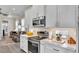 A modern kitchen displays white cabinets, stainless steel appliances, and an oven with a smooth cooktop surface at 3261 Fish Hawk Dr, Polk City, FL 33868